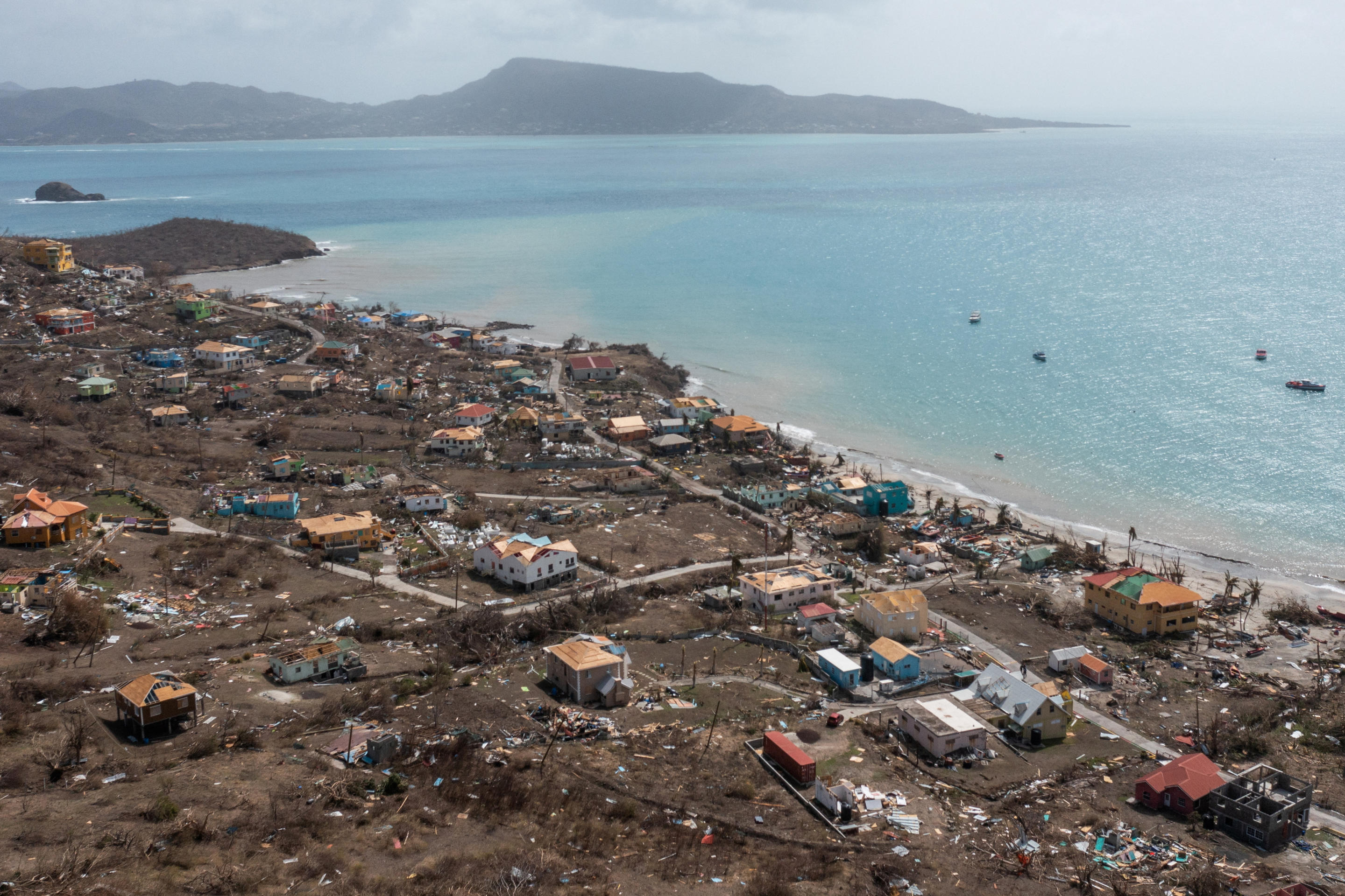 Scattered debris and houses with missing roofs are seen in a drone photo after Hurricane Beryl passed the island of Petite Martinique, Grenada. 