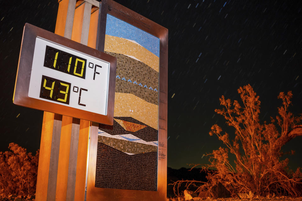 A sign displays the temperature of 110°F and 43°C at 10 p.m. outside the Furnace Creek Visitors Center in Death Valley National Park.