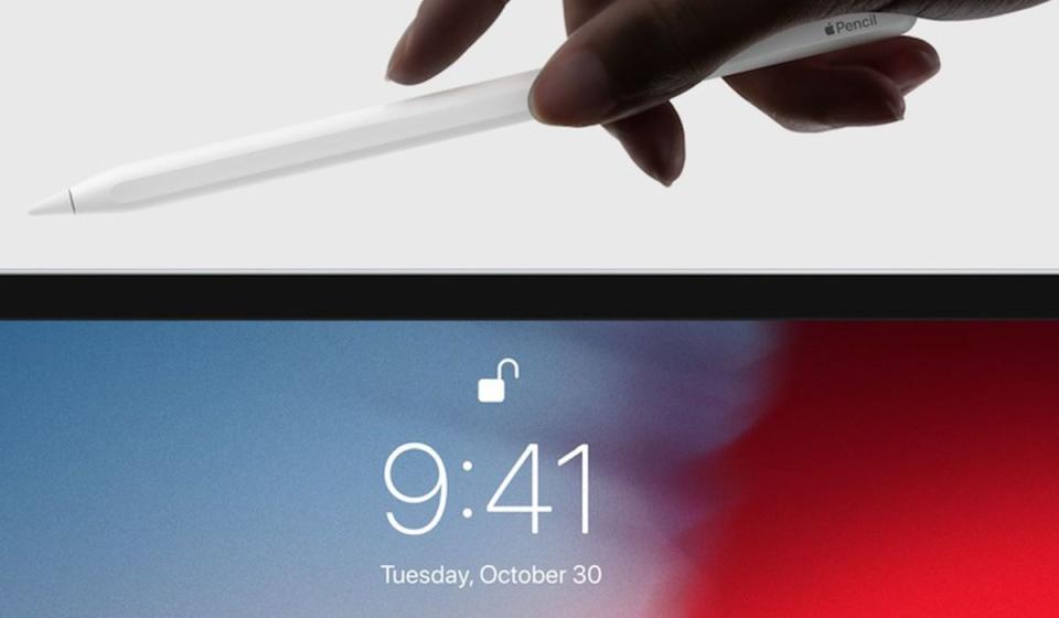 A photo of the Apple Pencil about to be magnetically attached to the top of an iPad.