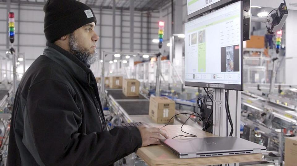 A worker at a Walmart automated distribution center