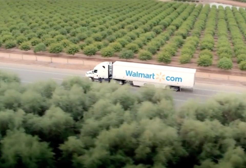 A Walmart truck driving through farmland