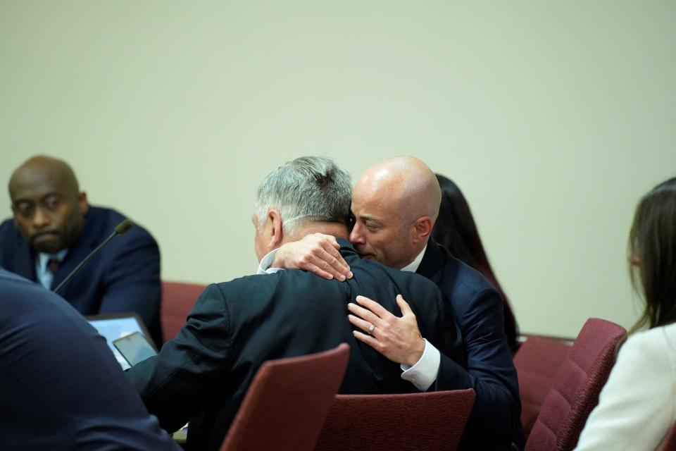 Attorney Luke Nikas embraces Alec Baldwin in the courtroom.