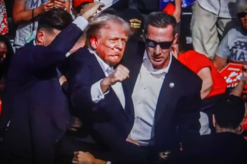 Former US President Donald Trump is rushed off stage by secret service after being struck by gunfire during his Presidential Election campaign rally in Butler Pennsylvania. Artem Priakhin/SOPA Images via ZUMA Press Wire/dpa