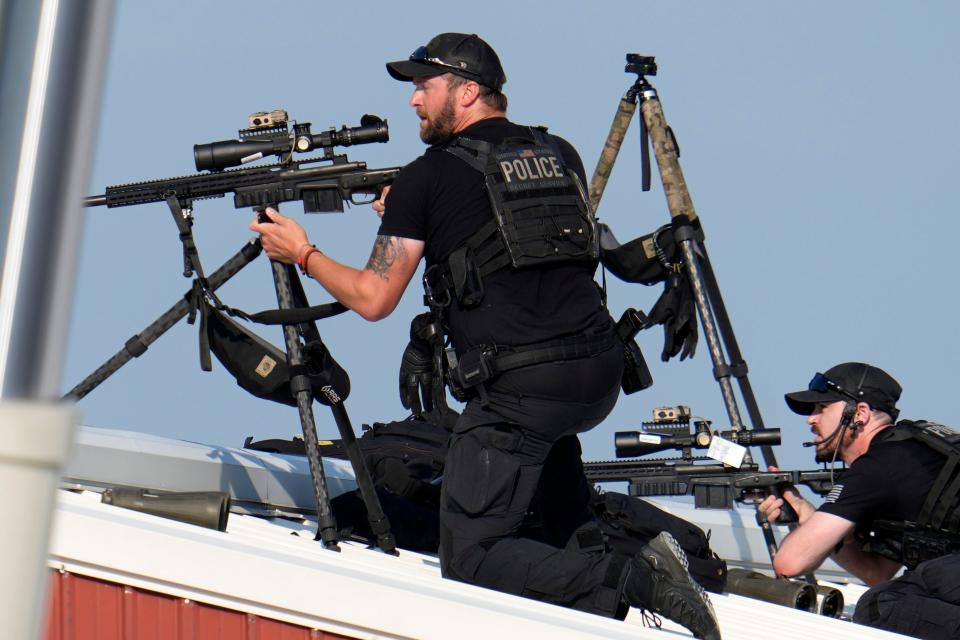 Police snipers return fire after shots were fired while Republican presidential candidate former President Donald Trump was speaking at a campaign event in Butler, Pa., on Saturday, July 13, 2024. (AP Photo/Gene J. Puskar)