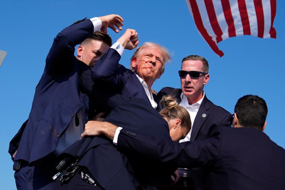 Republican presidential candidate former President Donald Trump is surround by U.S. Secret Service agents at a campaign rally, Saturday, July 13, 2024, in Butler, Pa. (AP Photo/Evan Vucci)