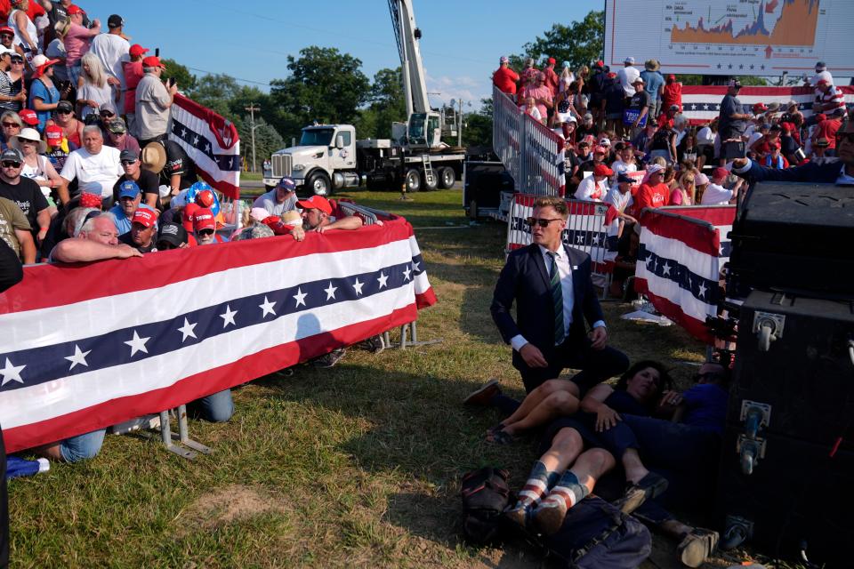 People react during a campaign rally with Republican presidential candidate former President Donald Trump at a campaign rally, Saturday, July 13, 2024, in Butler, Pa. (AP Photo/Evan Vucci)