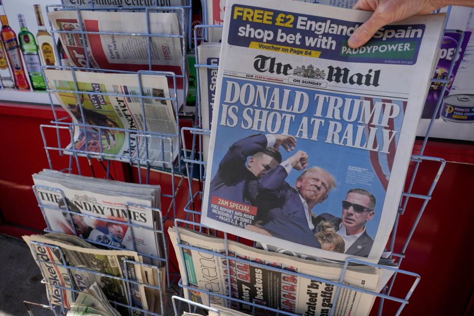 A woman buys a copy of the British Mail on Sunday newspaper at a newsagents in London, Sunday, July 14, 2024, showing the reaction to events at former President Trump's campaign rally in Butler, Pennsylvania. Donald Trump's campaign says he is 