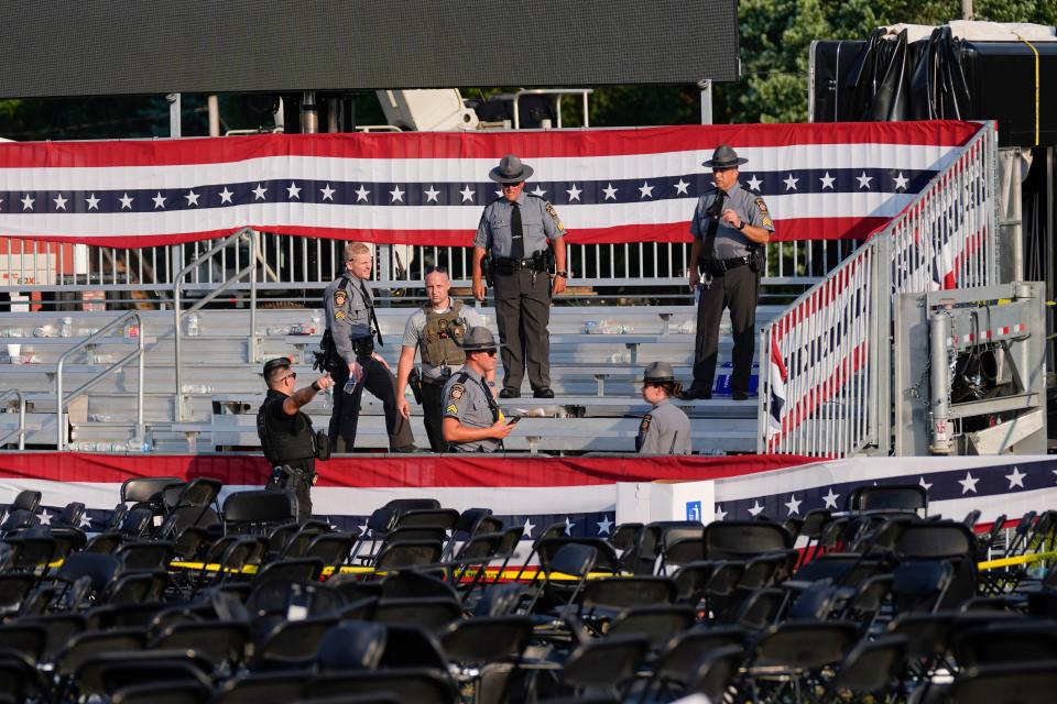 Law enforcement officers gather at campaign rally site for Republican presidential candidate former President Donald Trump is empty Saturday, July 13, 2024, in Butler, Pa. Trump's campaign said in a statement that the former president was 