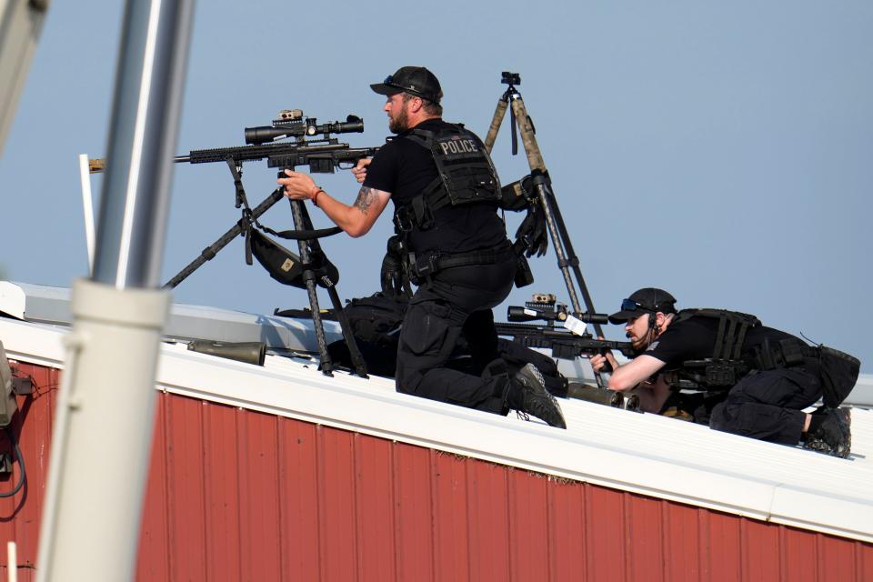 Police snipers return fire after shots were fired while Republican presidential candidate former President Donald Trump was speaking at a campaign event in Butler, Pa., on Saturday, July 13, 2024. (AP Photo/Gene J. Puskar)