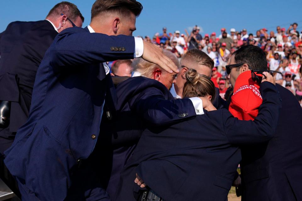 Republican presidential candidate former President Donald Trump is surrounded by U.S. Secret Service agents at a campaign rally, Saturday, July 13, 2024, in Butler, Pa. (AP Photo/Evan Vucci)