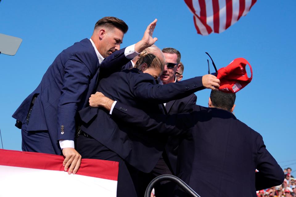 Republican presidential candidate former President Donald Trump is surrounded by U.S. Secret Service agents at a campaign rally, Saturday, July 13, 2024, in Butler, Pa. (AP Photo/Evan Vucci)