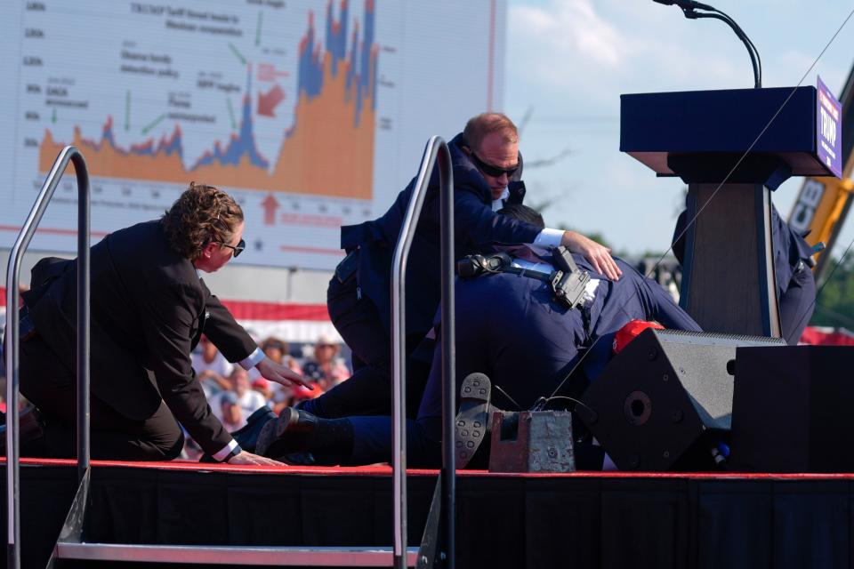 U.S. Secret Service agents converge to cover Republican presidential candidate former President Donald Trump at a campaign rally, Saturday, July 13, 2024, in Butler, Pa. (AP Photo/Evan Vucci)