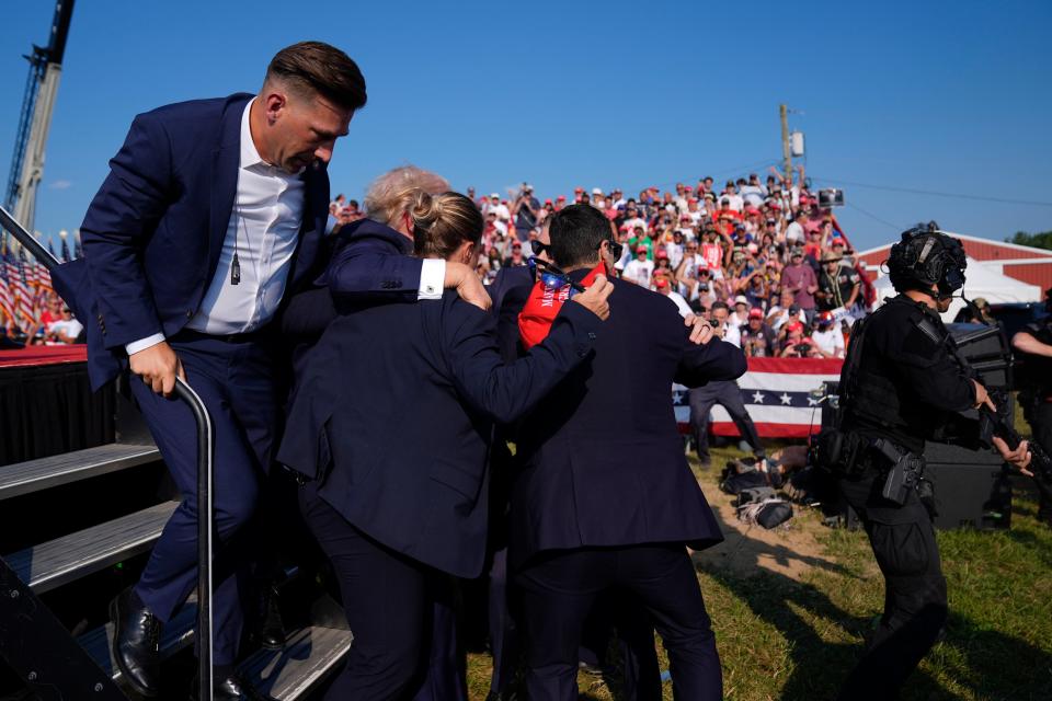 Republican presidential candidate former President Donald Trump is surrounded by U.S. Secret Service agents at a campaign rally, Saturday, July 13, 2024, in Butler, Pa. (AP Photo/Evan Vucci)