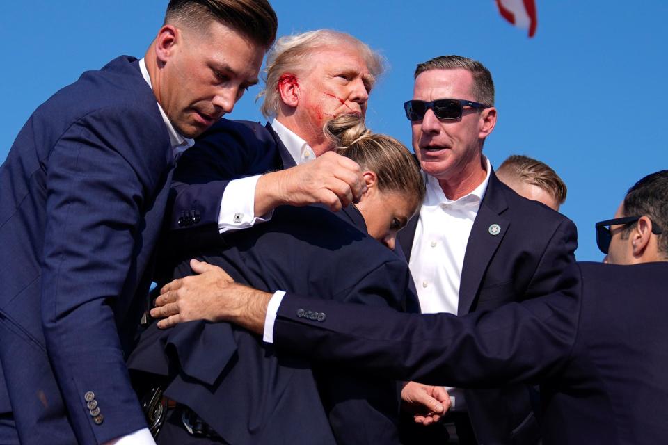 Republican presidential candidate former President Donald Trump is surrounded by U.S. Secret Service agents at a campaign rally, Saturday, July 13, 2024, in Butler, Pa. (AP Photo/Evan Vucci)