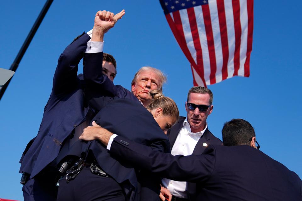 Republican presidential candidate former President Donald Trump is surrounded by U.S. Secret Service agents at a campaign rally, Saturday, July 13, 2024, in Butler, Pa. (AP Photo/Evan Vucci)