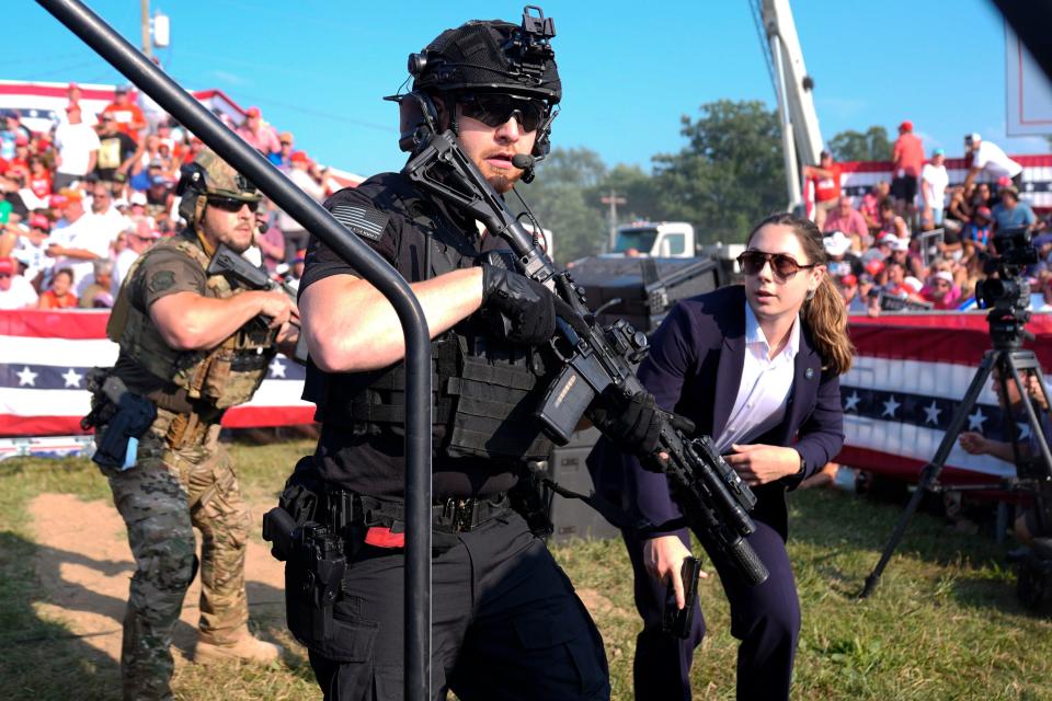 U.S. Secret Service agents respond as Republican presidential candidate former President Donald Trump is surrounded on stage by U.S. Secret Service agents at a campaign rally, Saturday, July 13, 2024, in Butler, Pa. (AP Photo/Evan Vucci)