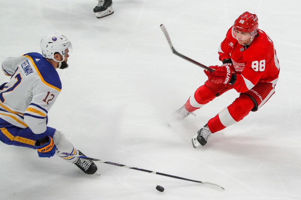 Detroit Red Wings right wing Patrick Kane (88) is defended by Buffalo Sabres left wing Jordan Greenway (12) during the first period at Little Caesars Arena in Detroit on Sunday, April 7, 2024.