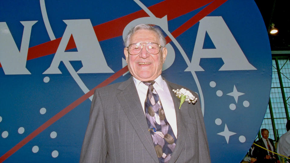 James Modarelli, as seen in 1997, posing with the NASA logo he designed. Modarelli died in 2002 at the age of 86.