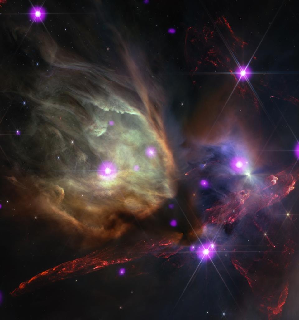 colorful wisps of gas in deep space in front of bright dots of light