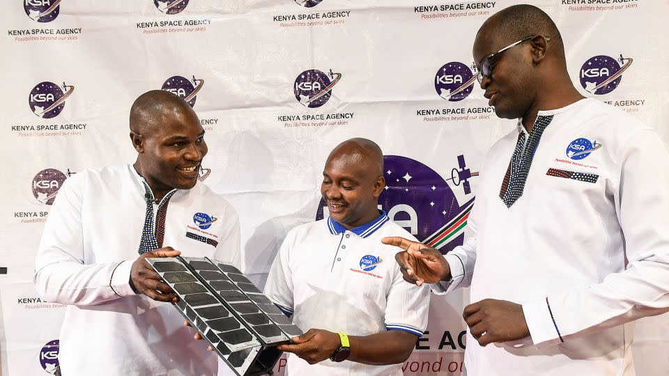 Kenya deployed its first Earth observation satellite, Taifa-1, into space in April 2023. It was developed and designed by Kenyans, but manufactured in Bulgaria. Here, Kenya Space Agency (KSA) engineers Aloyce Were (L), Deche Bungule (C) and Andrew Nyawade hold the prototype of Taifa-1 satellite at the University of Nairobi in April 2023. - Simon Maina/AFP/Getty Images