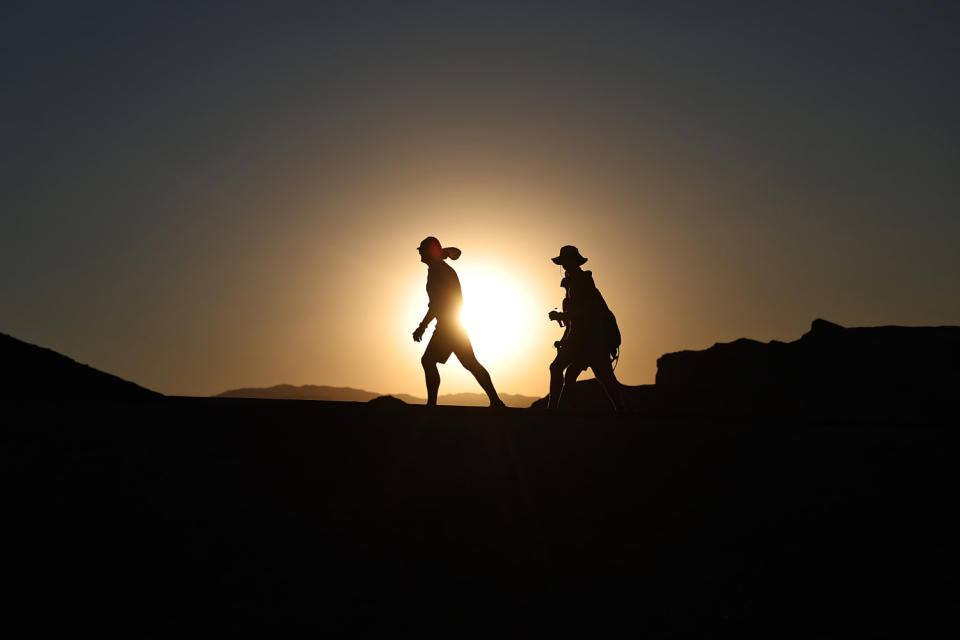 People brave the heat before sunset during a long-duration heat wave in Death Valley National Park, Calif. (Mario Tama / Getty Images)