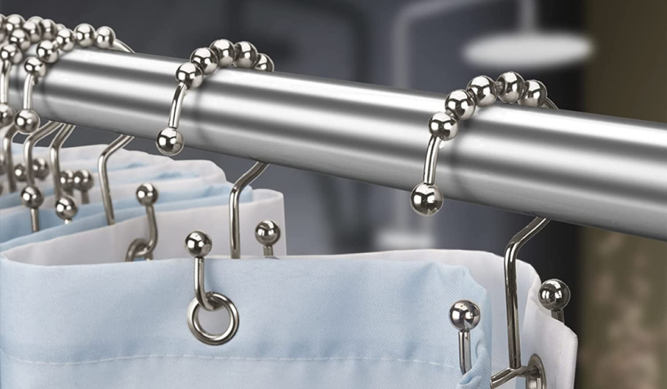 Double-sided shower curtain hooks hanging on a shower rod