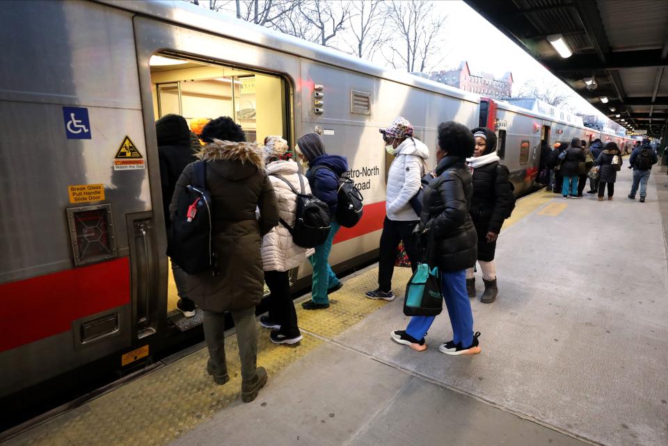 Health care workers in scrubs board a northbound Metro-North train from the Fordham Station in the Bronx, Feb. 8, 2024.