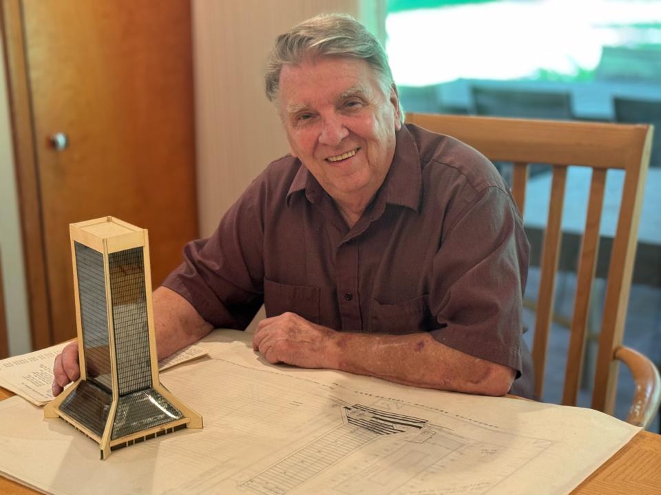 Larry Denny with an Independent Life building scale model he made while working for KBJ Architects.