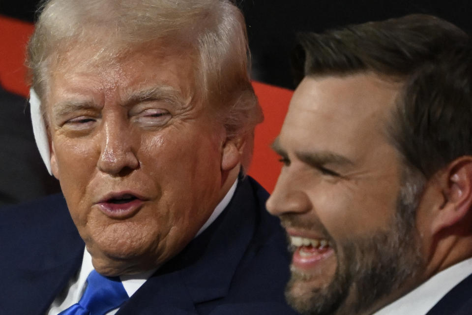 TOPSHOT - Former US President and 2024 Republican presidential candidate Donald Trump (L) speaks to US Senator from Ohio and 2024 Republican vice presidential candidate J.D. Vance during the second day of the 2024 Republican National Convention at the Fiserv Forum in Milwaukee, Wisconsin, July 16, 2024. Days after he survived an assassination attempt Donald Trump won formal nomination as the Republican presidential candidate and picked right-wing loyalist J.D. Vance for running mate, kicking off a triumphalist party convention in the wake of last weekend's failed assassination attempt. (Photo by ANDREW CABALLERO-REYNOLDS / AFP) (Photo by ANDREW CABALLERO-REYNOLDS/AFP via Getty Images)