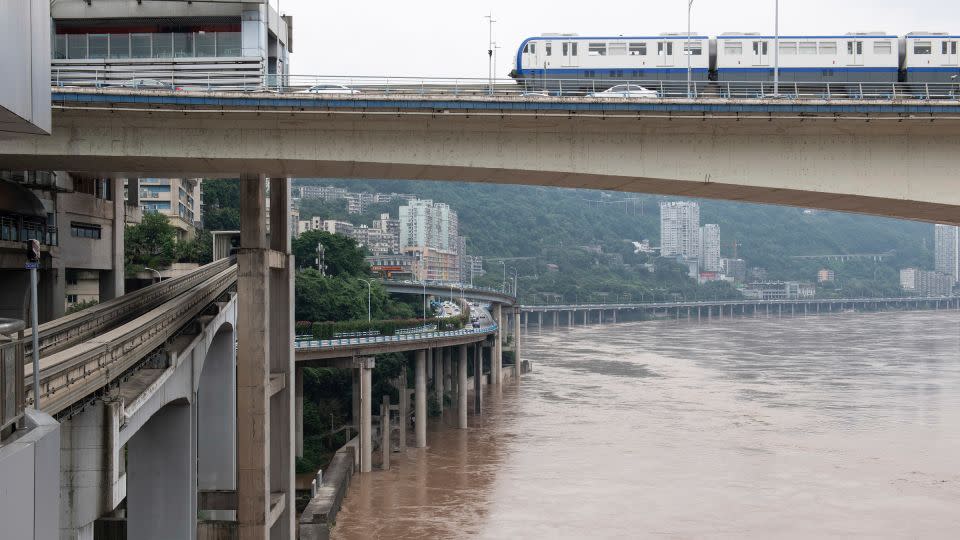 Floodwater flows through urban areas in Chongqing on July 12, 2024. - VCG/AP