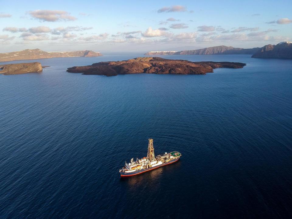 aerial view of ship on blue sea with islands in background