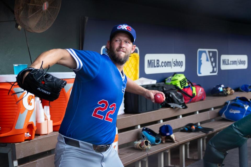 Clayton Kershaw goes through his pitching motion in the dugout before his rehab start for triple-A Oklahoma City last Friday.