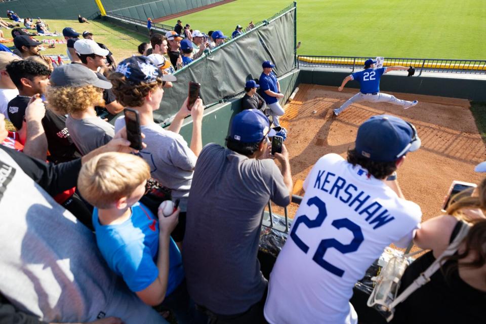 Fans watch Clayton Kershaw warm up for a rehab start for Oklahoma City in Round Rock, Texas, last Friday.