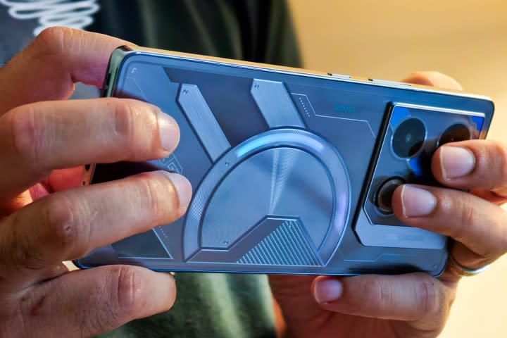 Infinix GT 20 Pro gaming phone with RGB back lighting held in hand.