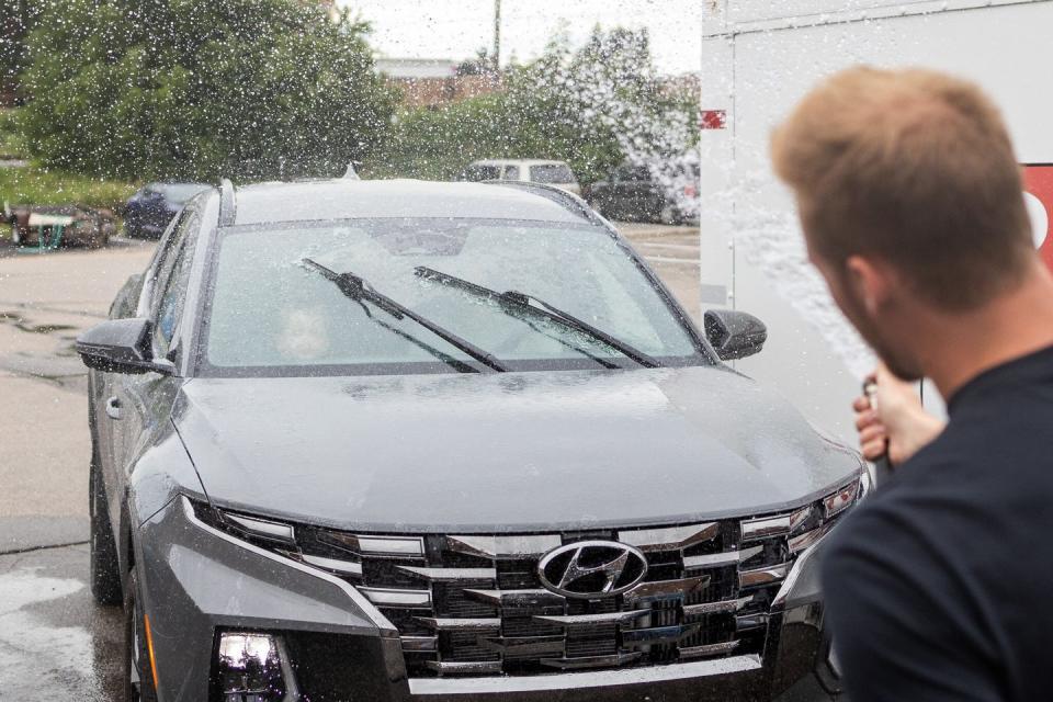 a man spraying water on a truck