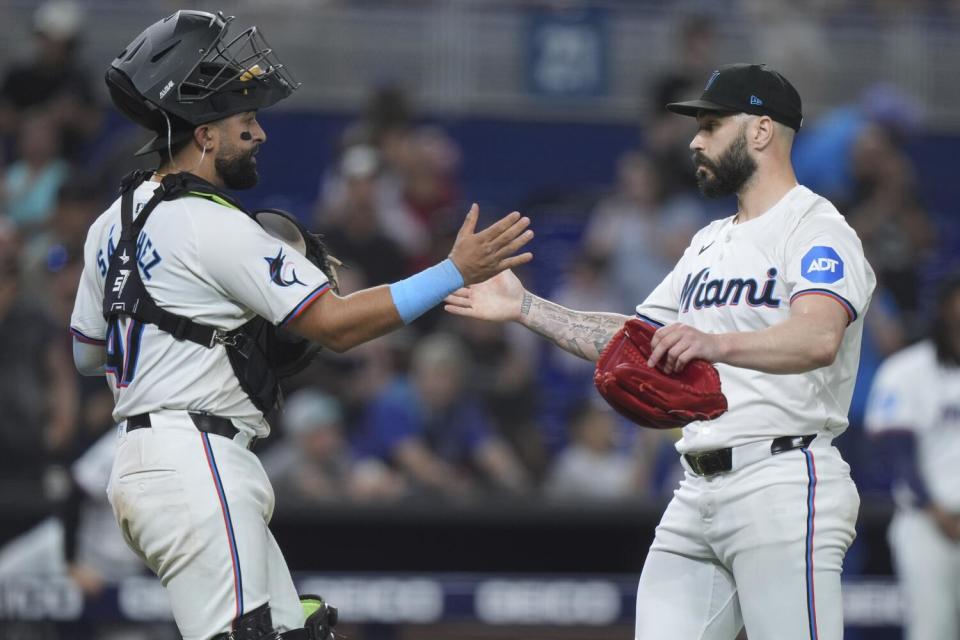 Catcher Ali Sánchez, left, and pitcher Tanner Scott congratulate each other after the Marlins beat the Orioles.