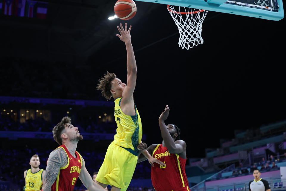 Australia's #01 Dyson Daniels goes to the basket despite Spain's #10 Juancho Hernangomez (L) and Spain's #16 Usman Garuba in the men's preliminary round group A basketball match between Australia and Spain during the Paris 2024 Olympic Games at the Pierre-Mauroy stadium in Villeneuve-d'Ascq, northern France, on July 27, 2024. (Photo by Thomas COEX / AFP) (Photo by THOMAS COEX/AFP via Getty Images)