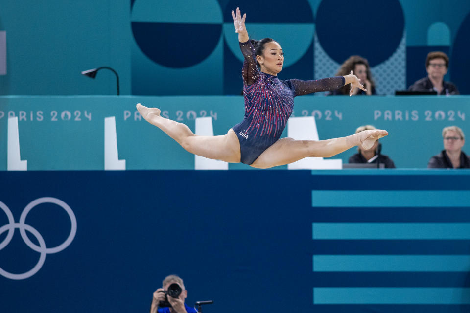 Sunisa Lee leaping into the air.