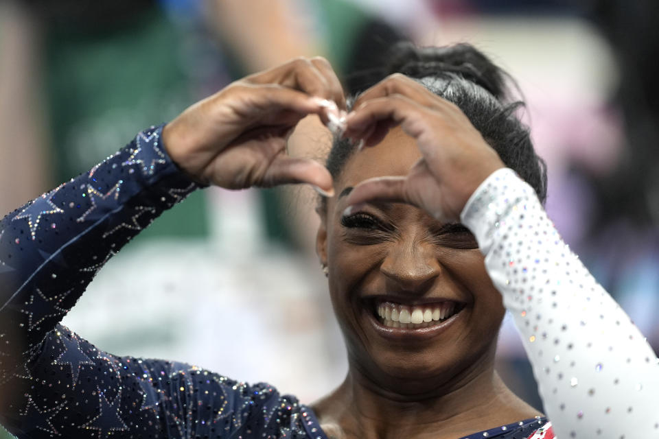 Simone Biles sends a heart gesture to the crowd at Bercy Arena in Paris.