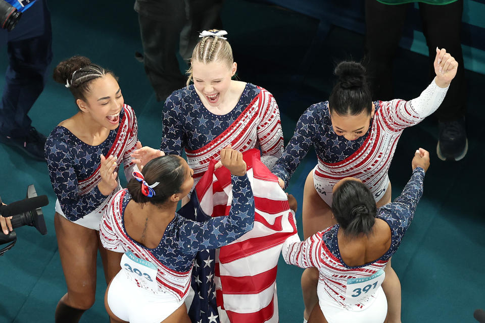 Team USA celebrates its win in the team gymnastics competition. 