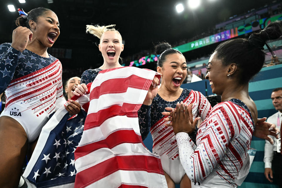 Team USA celebrates its first place in the gymnastics competition. 