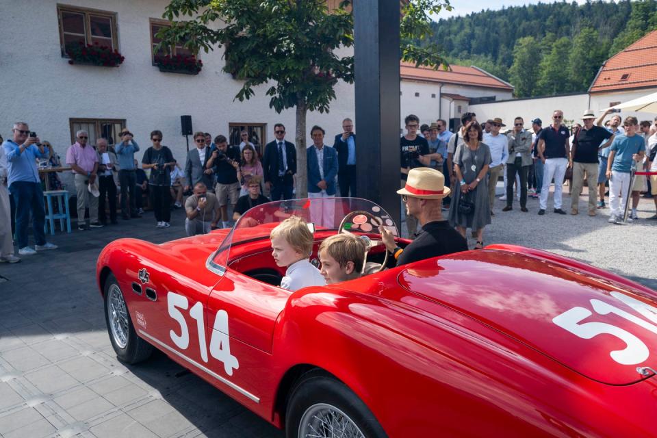 a group of people in a convertible car