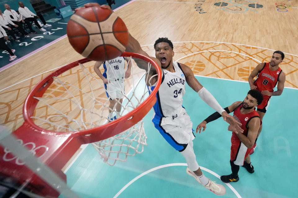 TOPSHOT - Greece's #34 Giannis Antetokounmpo dunks the ball in the men's preliminary round group A basketball match between Greece and Canada during the Paris 2024 Olympic Games at the Pierre-Mauroy stadium in Villeneuve-d'Ascq, northern France, on July 27, 2024. (Photo by POOL / AFP) (Photo by -/POOL/AFP via Getty Images)