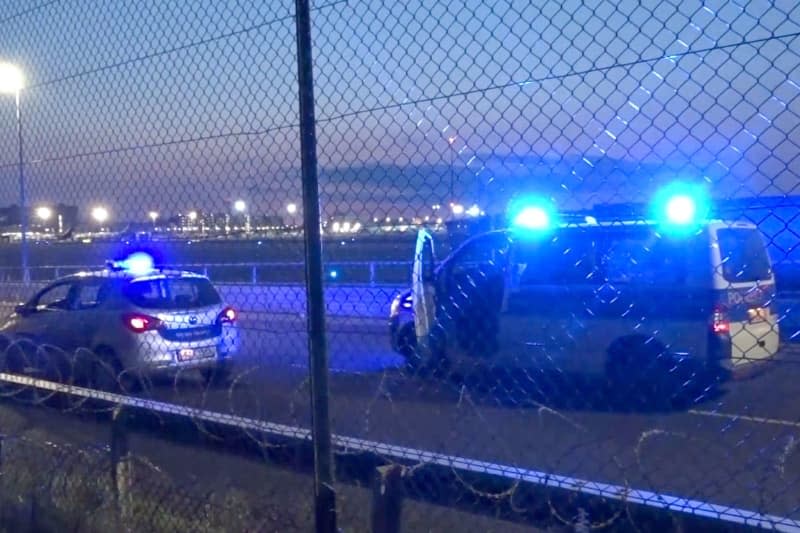 Police vehicles are parked near the tarmac at Frankfurt Airport. Air traffic has been temporarily suspended due to an action by climate activists. Mike Seeboth/TNN/dpa