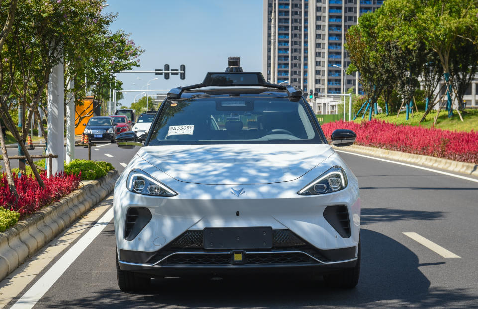WUHAN, CHINA - AUGUST 08: A Baidu's Apollo Go self-driving taxi moves along a road on August 8, 2022 in Wuhan, Hubei Province of China. Baidu's Apollo Go was authorized to charge fares for robotaxi services in Wuhan. (Photo by VCG/VCG via Getty Images)