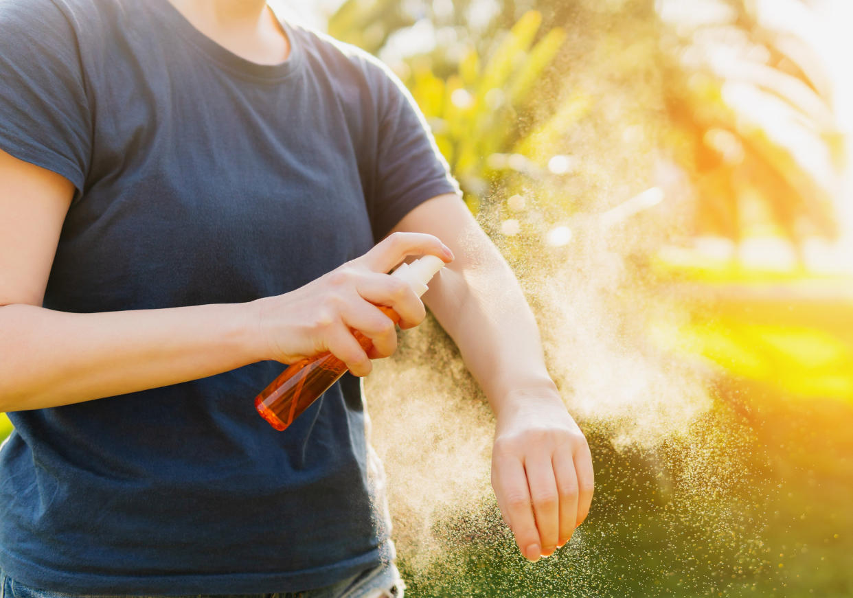 person applying bug spray