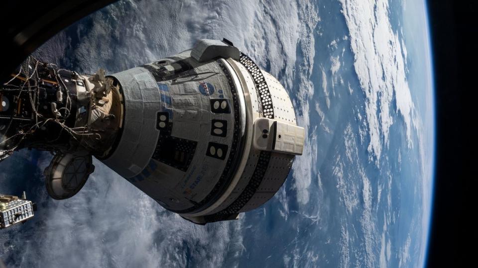  A cone-shaped spacecraft visible above the curve of earth, with clouds . 