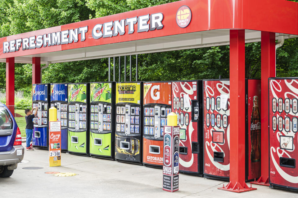 A boy uses a vending machine at a Coca-Cola gas station refreshment center in Asheville, North Carolina. (Jeffrey Greenberg/Universal Images Group via Getty Images)