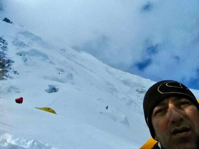 Colibasanu's selfie on Gasherbrum II, showing a snow slope with seracs behind.