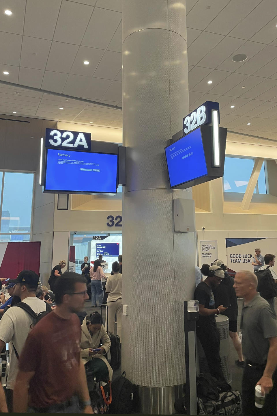 Travelers wait during an outage at Los Angeles International Airport on Friday, July 19, 2024 in Los Angeles. (AP Photo/Jason Dearen)